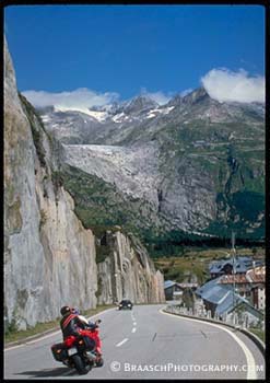 Glacier Recession. Climate change. Global warming. Rhone glacier, 2001, formerly covered valley at Gletch, Switzerland. Roads. Alps. Mountains. Rocks,rock