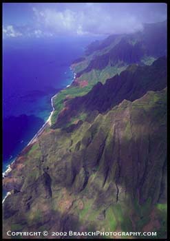 Na Pali Coast of Kauai, Hawaii, seen from helicopter. Deeply eroded volcanic ridges fall to Pacific Ocean. Aerial. Geology. Cliffs. Erosion